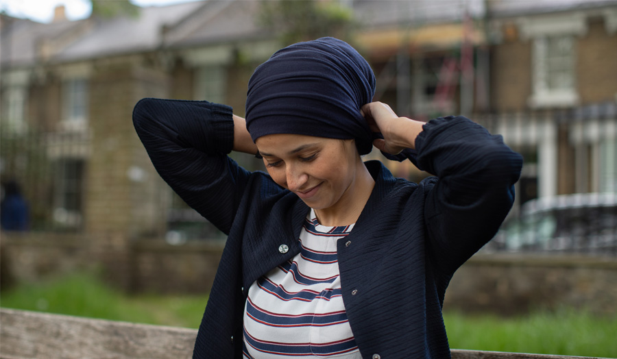 London Met graduate Hasnai wearing a blue cardigan