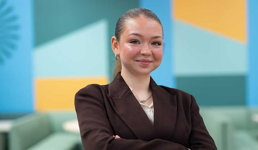 Iulia pictured smiling in a suit in the Met cafe