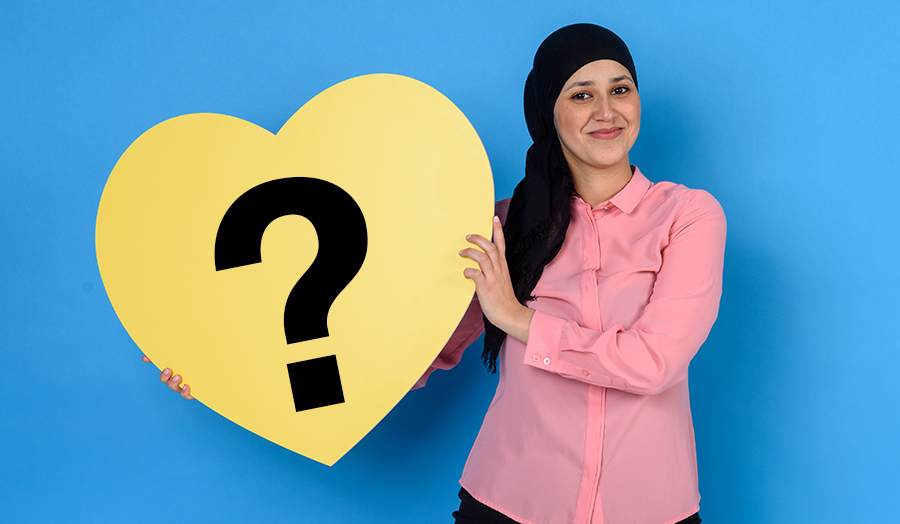 Student holding a heart with a question mark in it