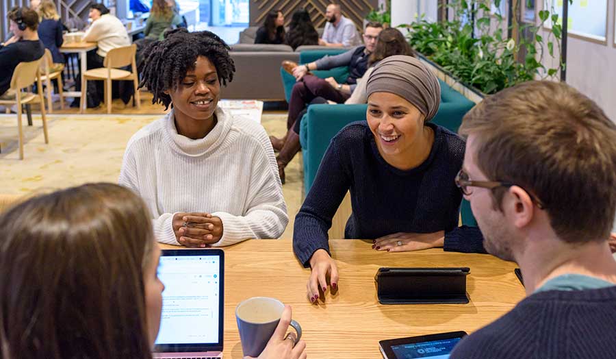 Group of students and staff in a meeting at London Met's accelerator