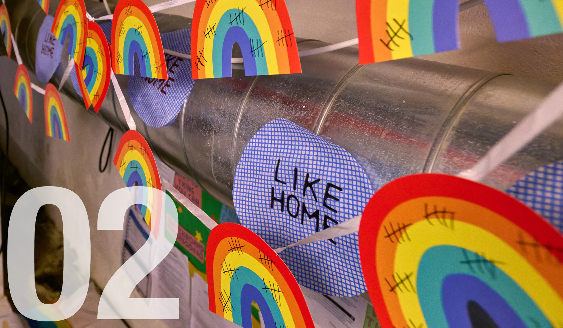 student rainbow artwork with 'Like home' on pipes in a London Met art studio