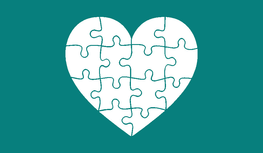 Jigsaw heart on green background