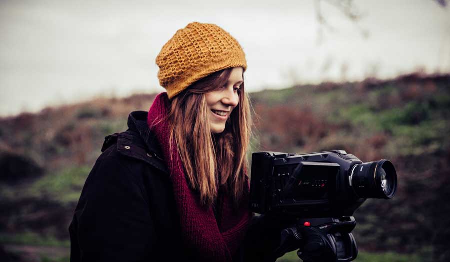 Student filming with a video camera