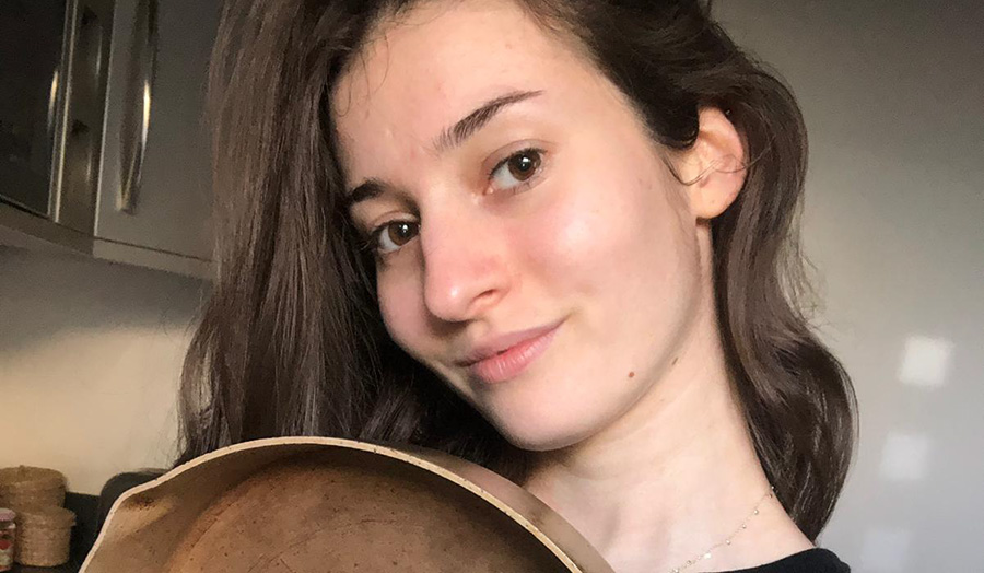 Student Maria Karelina holding a frying pan