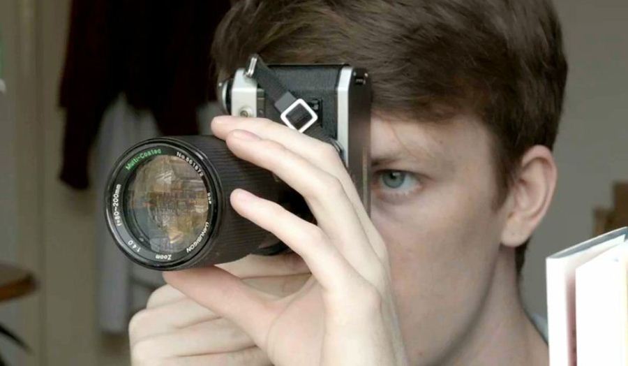 A man taking a picture, close up of his face behind the camera