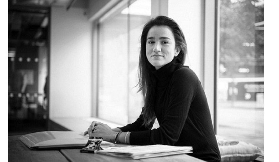 black and white profile shot of julia king sitting at table 