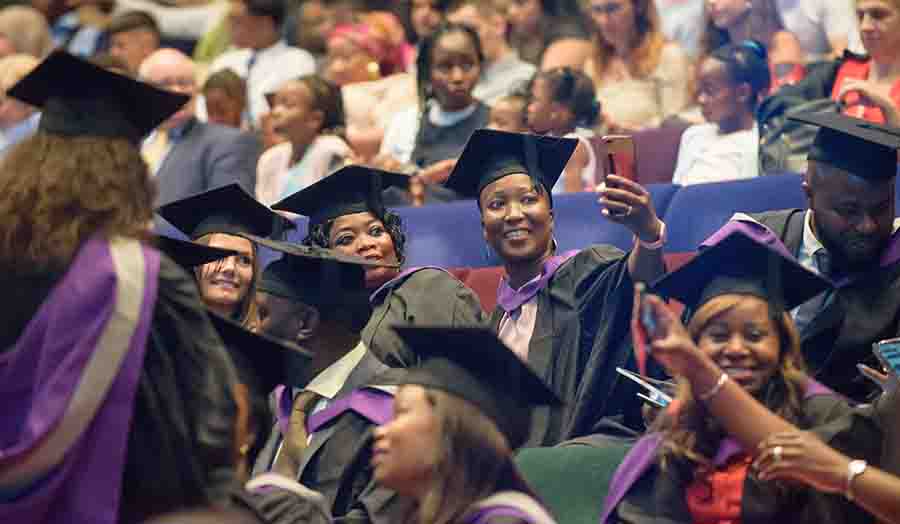 Students taking a selfie during their graduation ceremony