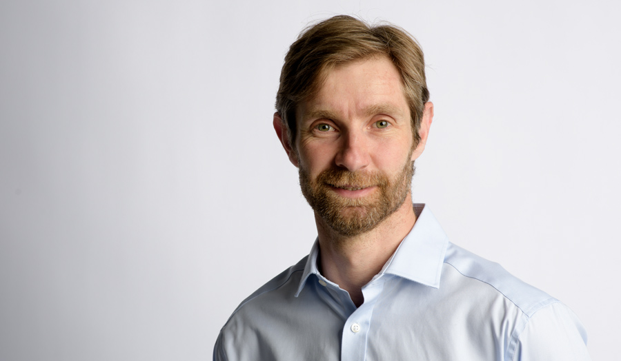 Portrait of Justin Webb in a light blue shirt