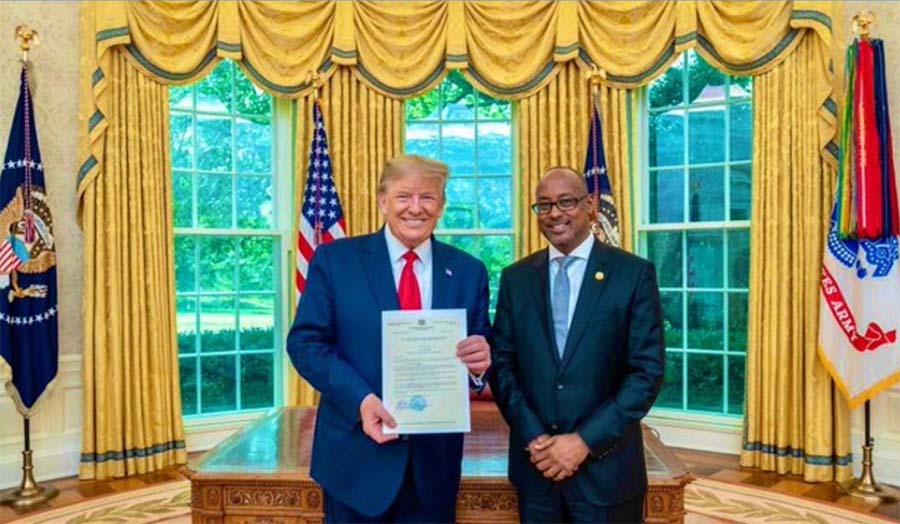 Ambassador Ali Sharif Ahmed standing next to President Donald Trump in the White House