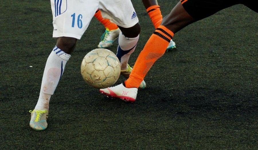 Two men playing football.