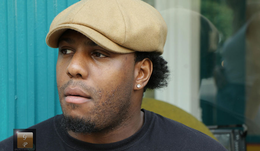 man wearing hat looking away from camera