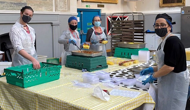 people packing food into boxes