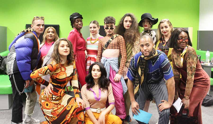Models for the catwalk posing in second-hand clothes