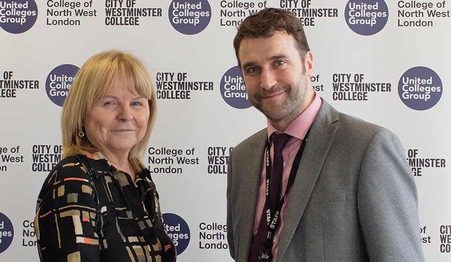 Lynn Dobbs and James Wilson stand for a photo behind a United Colleges Group banner.