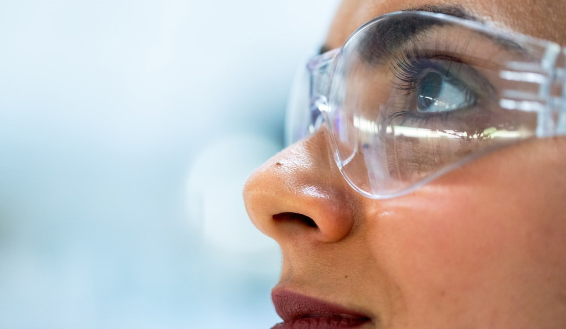 A scientist wearing safety glasses