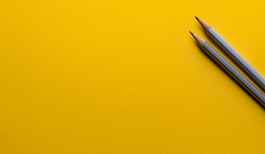 pencils against a yellow background