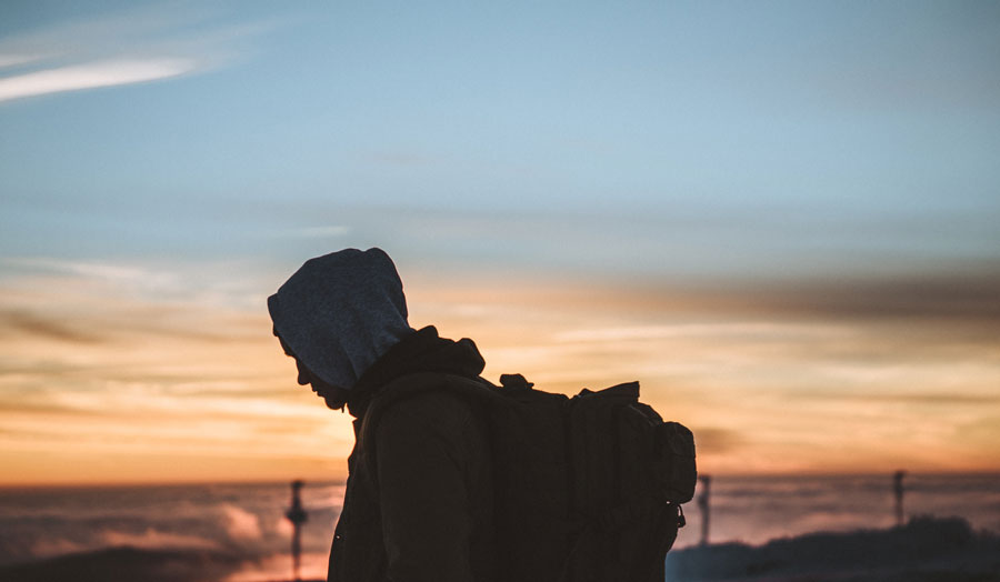 silhouette of man with backpack