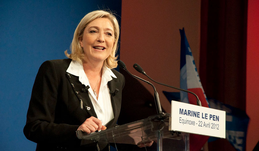 French nationalist Marine Le Pen speaking at a lectern