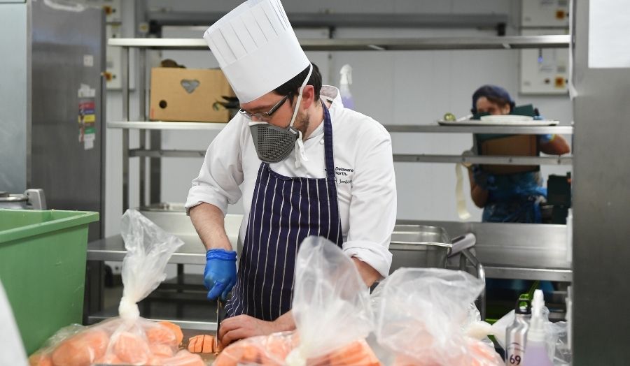 A volunteer chef makes meals to feed the hungry.