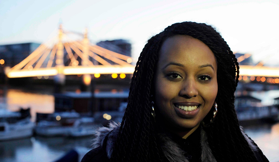 Warsan Shire standing by a river.