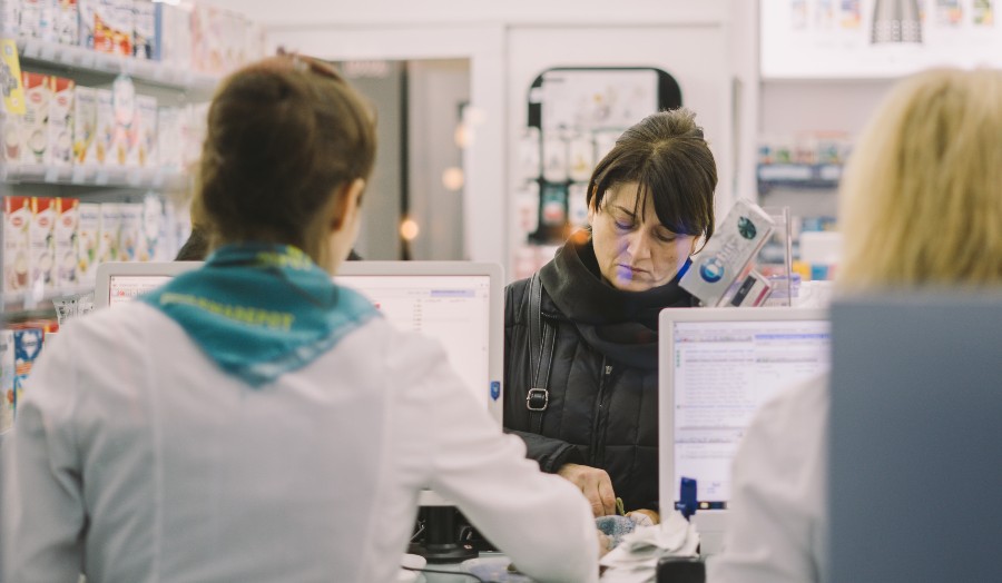 woman filling a prescription at a pharmacy