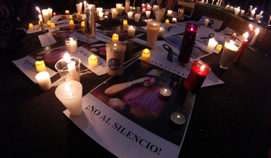 candles surrounding a photo of a man, a vigil for murdered journalist Javier Valdez