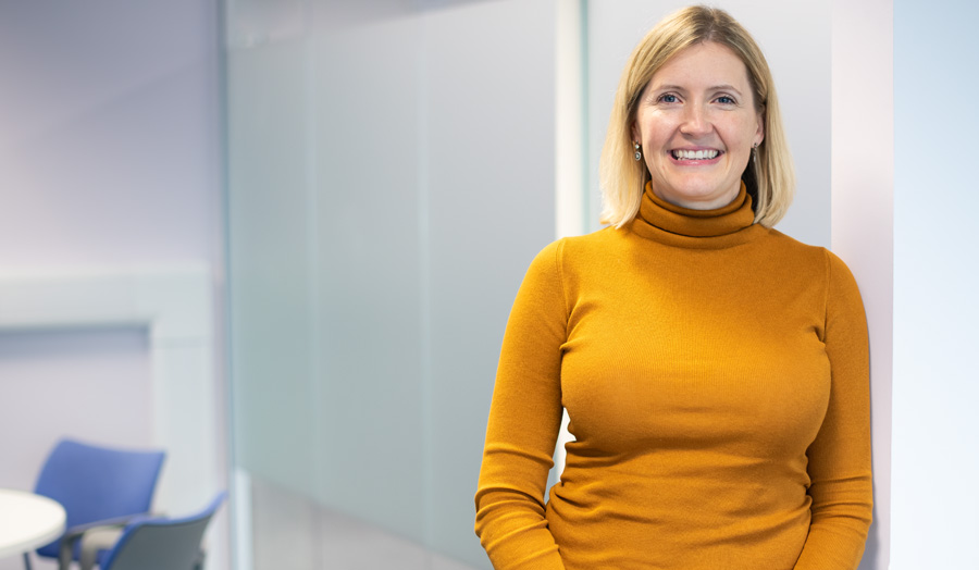 Woman in yellow jumper smiling