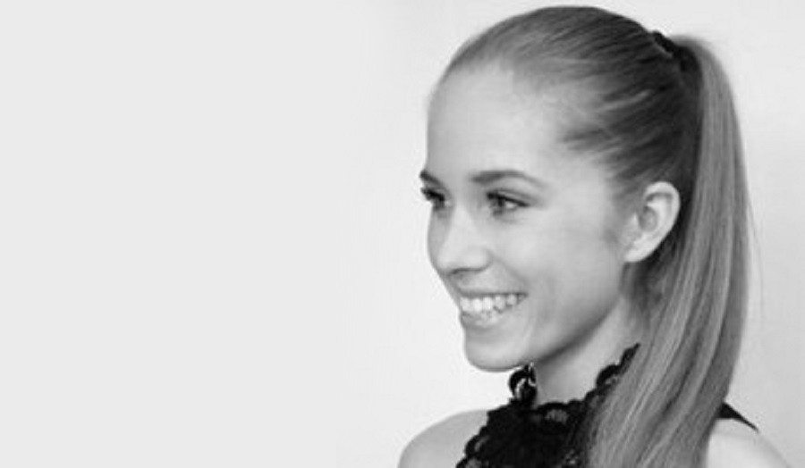 Black and white image of young woman with ponytail