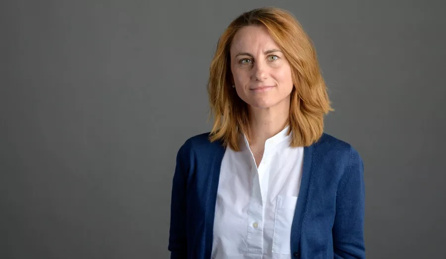 woman looking at camera against dark backdrop