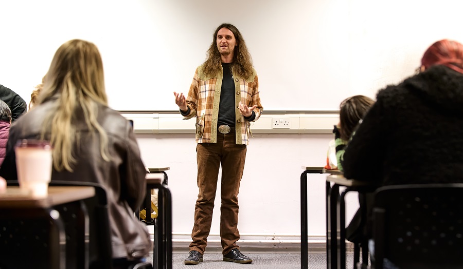 man delivering lecture to students