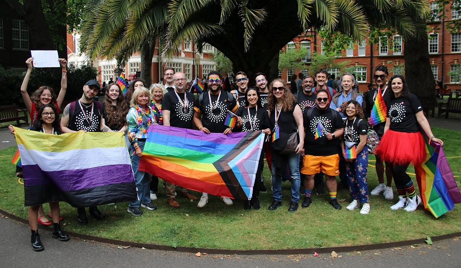 A large group of London Met staff and students with Pride flags