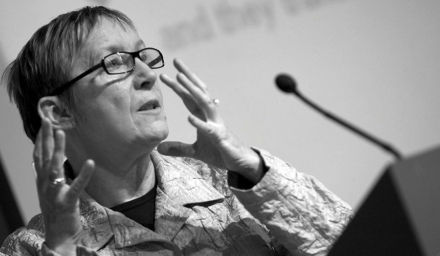Professor Liz Kelly speaking at a podium