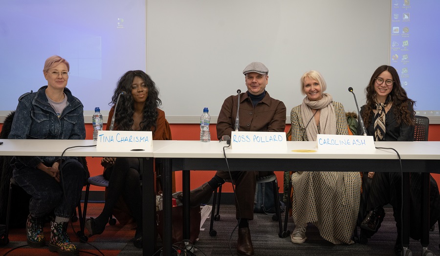 five people sitting on a panel