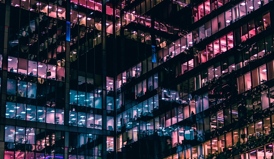 office building at night with lit up windows