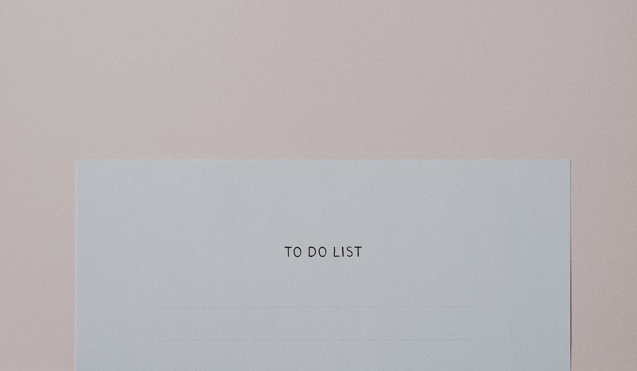 a piece of paper with the words 'to do list' on a pink background
