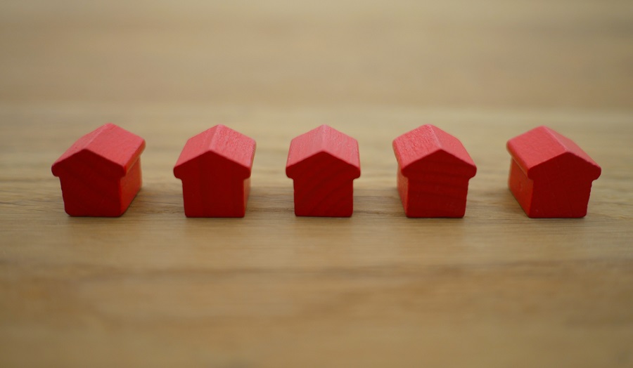 row of red wooden toy houses