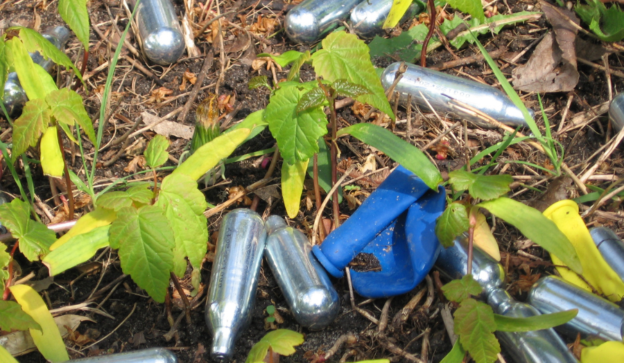 Nitrous oxide laughing gas canisters littered on the ground