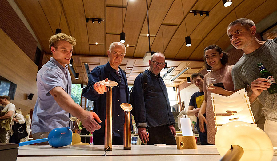 People looking at products in a design show in the centre of the frame