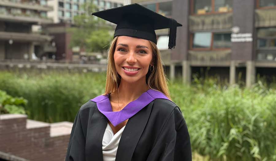 A woman with long hair with cap and gown