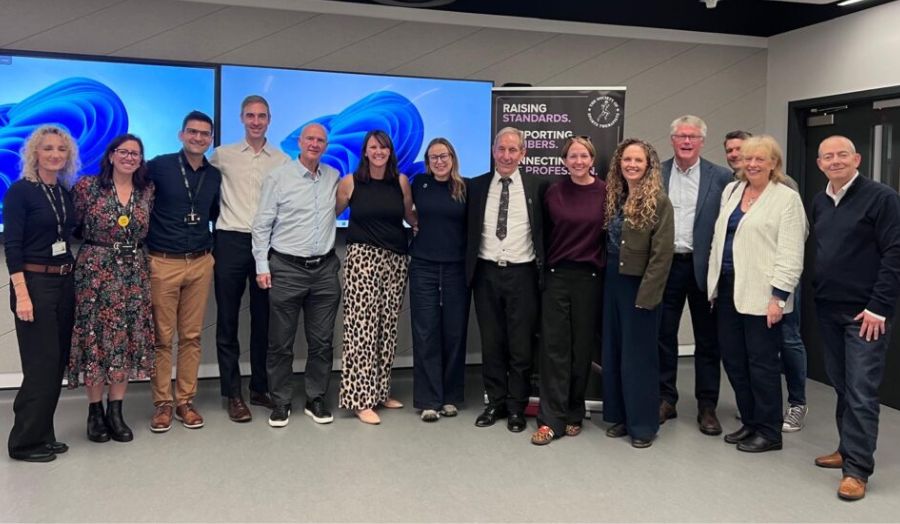 A group of professionals pose for a photo at an industry event