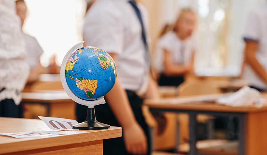 Globe on desk in a classroom