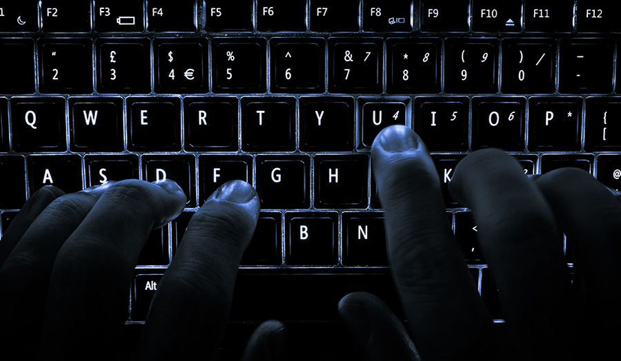 Hands over a backlit keyboard