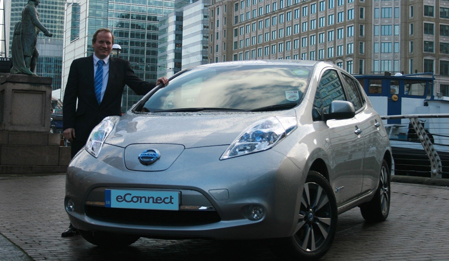 Head of eConnect Cars stands next to a nissan leaf