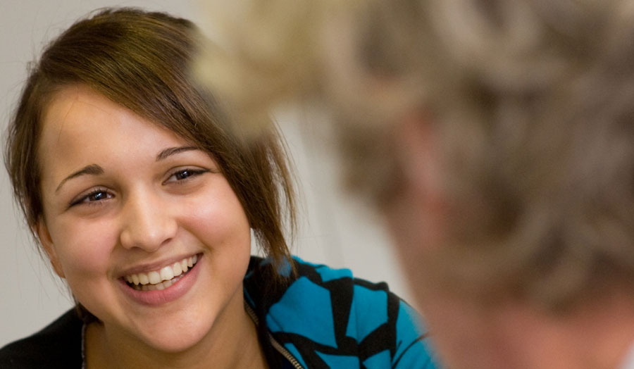 A close-up of a female student smiling