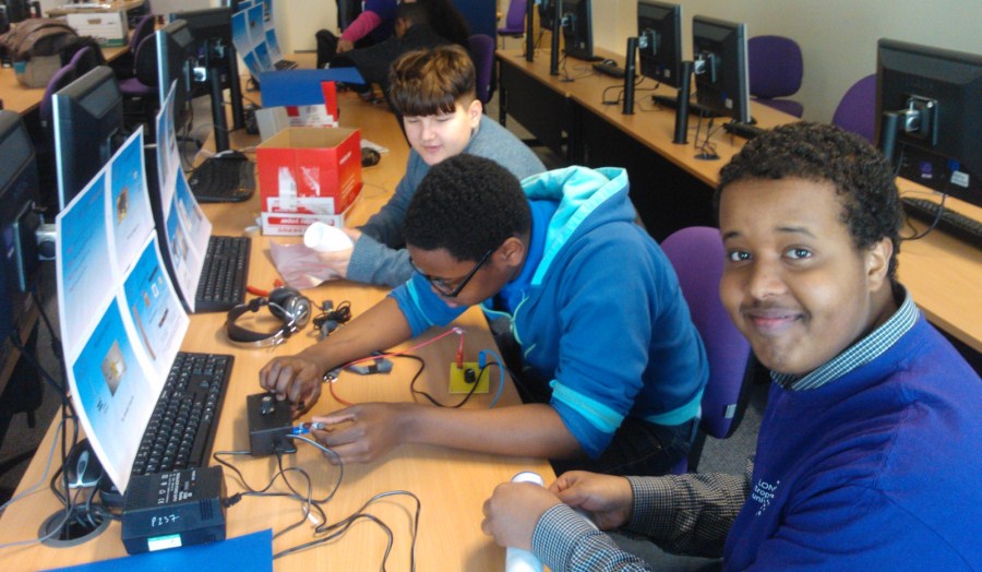 School pupils building robots in computer lab