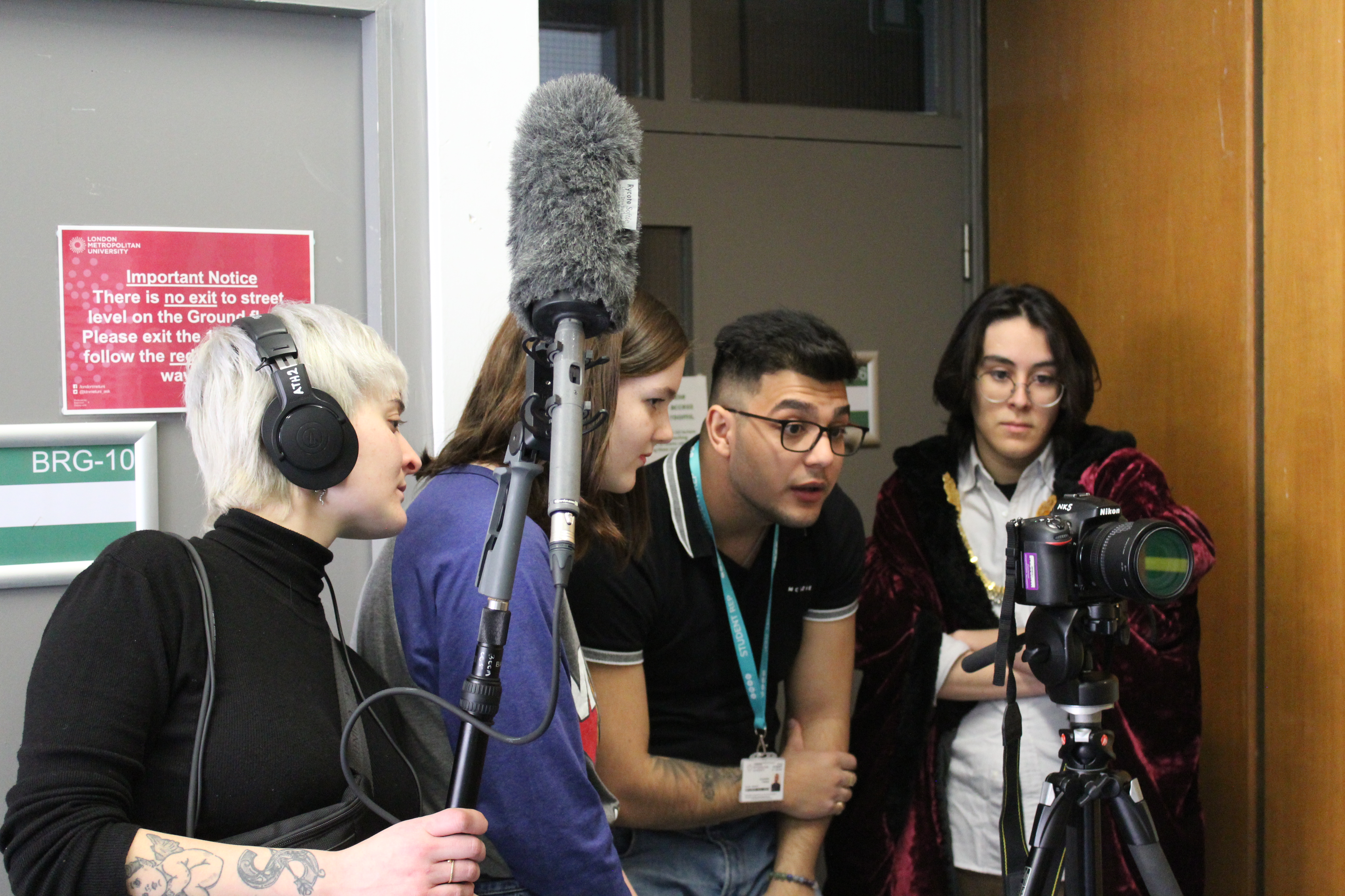 Student film makers with cameras and a microphone 