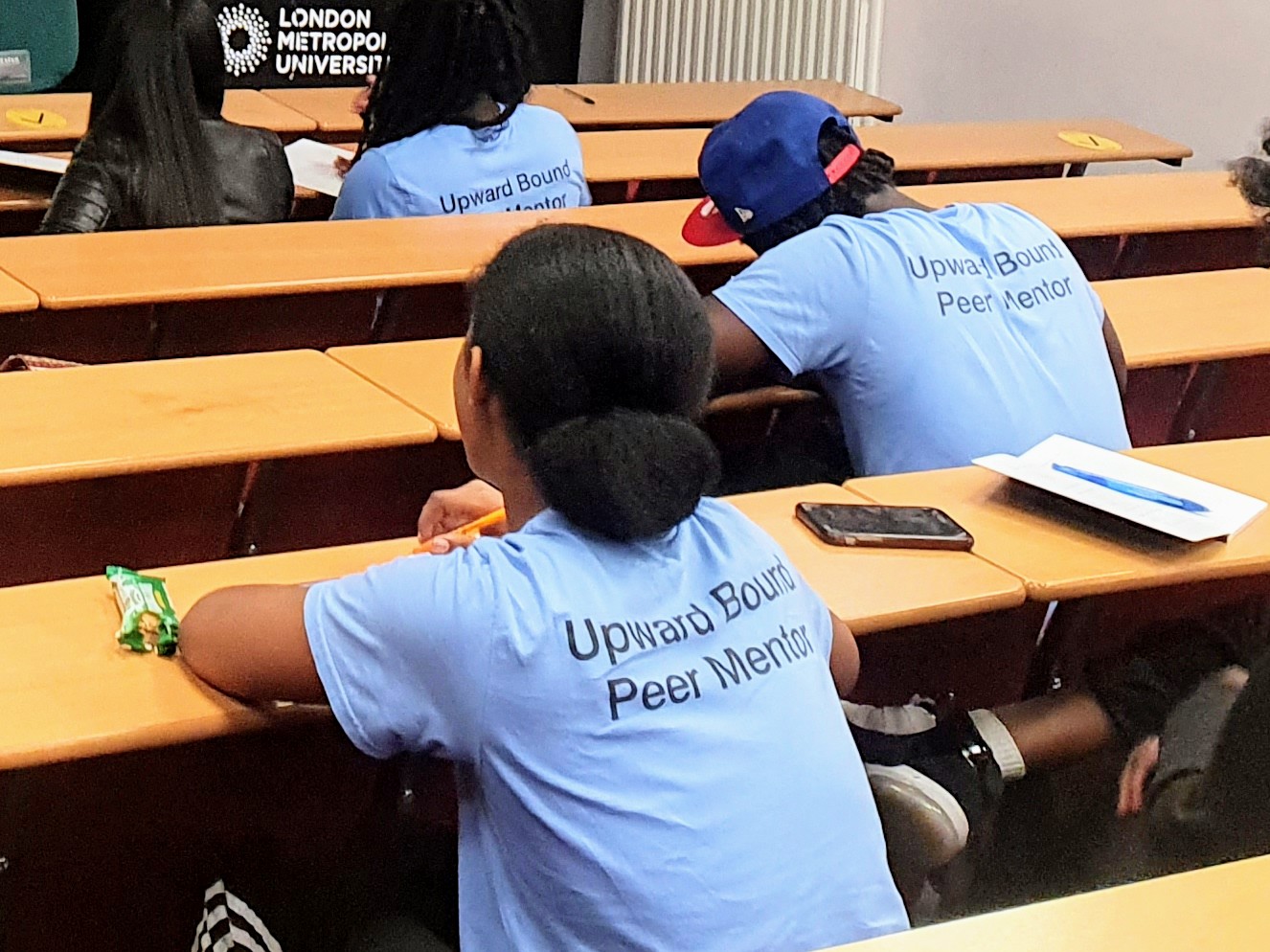 Upward Bound peer mentor sitting in a classroom