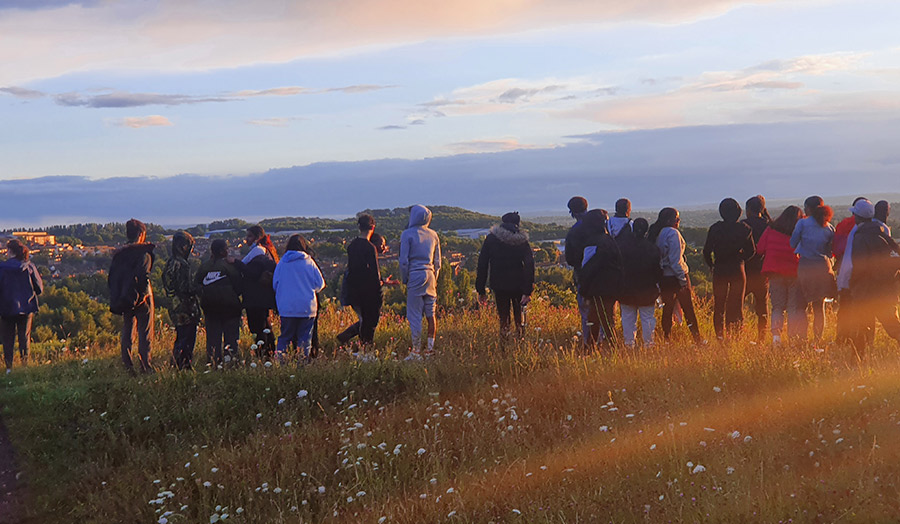 Group of Upward Bound students looking out over a beautiful view on their residential trip