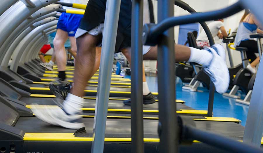 Close-up of students running on a treadmill