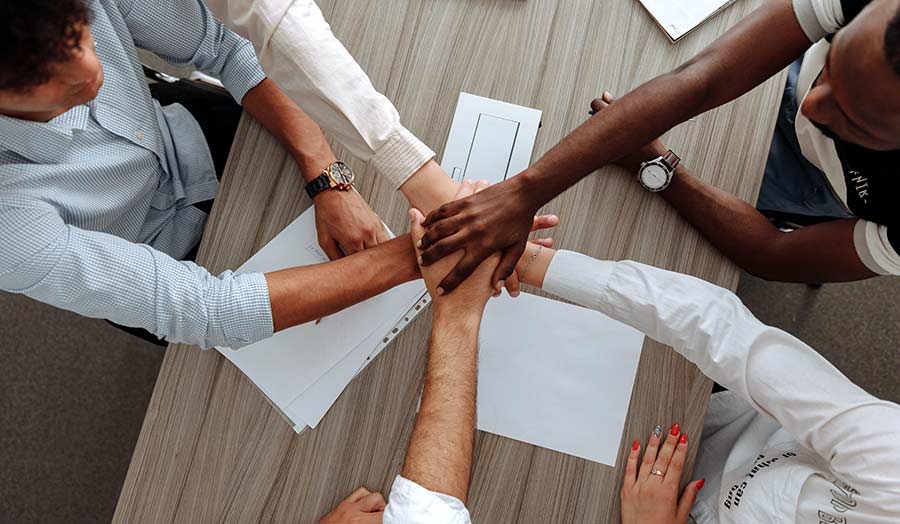 Hands together as a sign of agreement of the members of a team